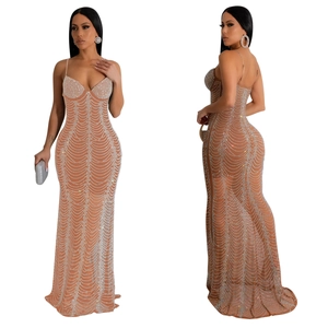 Detailed view of rhinestone wave patterns on a beige bodycon evening dress