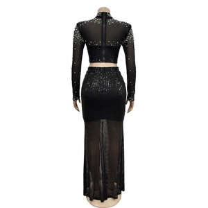 Close-up of mesh sleeves with pearl beads and back zipper on this black formal dress