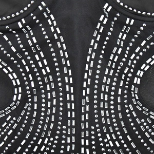 Macro view of black mesh dress featuring intricate silver rhinestones and sequins