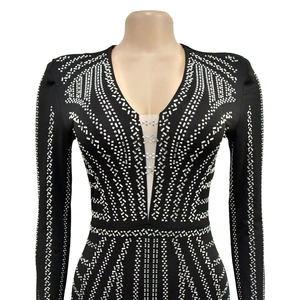Detail of black V-neck dress with silver rhinestone patterns and mesh stitching