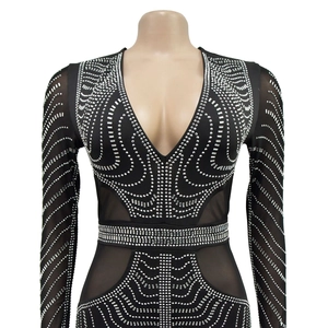 Detail of black V-neck dress with silver rhinestones and sheer mesh sleeves