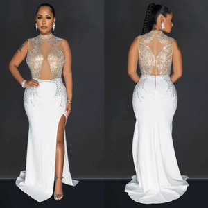 White halter neck dress with mesh details, sparkling crystals, and high side slit