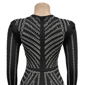Detail of silver rhinestones and invisible zipper on the back of a black bodycon dress