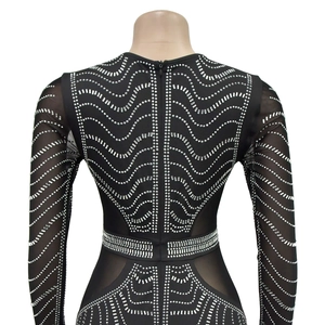 Close-up of black mesh maxi dress featuring wave patterns of shimmering silver rhinestones