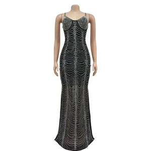 Close-up of mesh evening dress featuring sparkling silver rhinestones in wave patterns