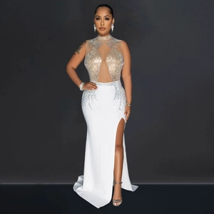 Close-up of white mesh evening gown with sparkling rhinestones and high side slit