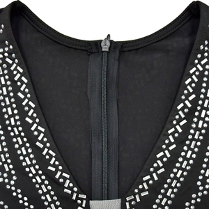 Close-up of deep V-neckline with silver rhinestones and metal zipper on black dress