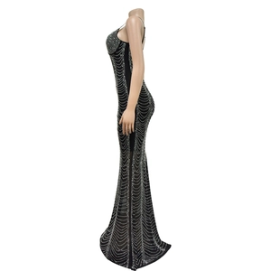 Detail of black fitted evening gown with shimmering silver rhinestones in draped patterns