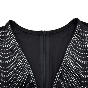 Detail of V-neckline featuring shiny silver rhinestones and square sequins on black fabric