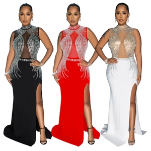 Detail of high neck mesh patchwork evening gown with sparkling rhinestones and high slit