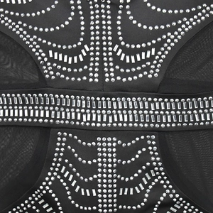 Detailed view of black mesh dress with symmetric crystal rhinestones and silver sequins