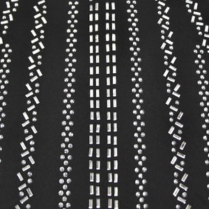Detail of silver rhinestones in vertical striped pattern on black evening dress fabric