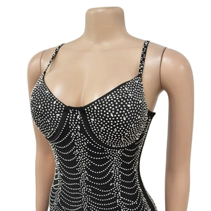 Detail of black mesh camisole dress featuring sparkling silver rhinestones in wave patterns