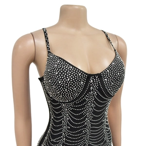Close-up of black mesh dress featuring silver rhinestone patterns and thin shoulder straps