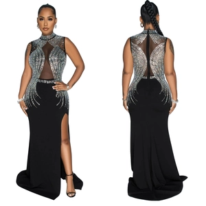 Detail of black mesh evening dress with silver rhinestone crystals and high side slit