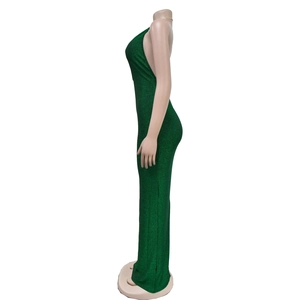 Side view of dark green bodycon maxi dress with backless halter design and glitter fabric