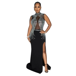 Detail of sheer mesh patchwork with sparkling rhinestones on black evening gown