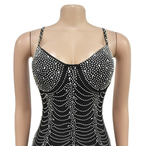Detail of black mesh evening dress featuring silver rhinestones in a wave pattern