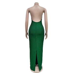 Detail view of emerald green backless maxi dress with subtle metallic shimmer and back slit