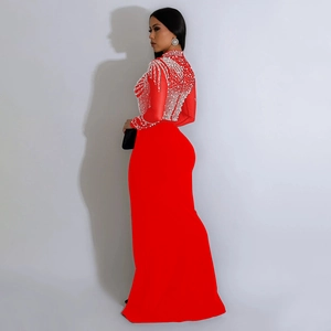 Detailed close-up of red mesh gown with intricate beadwork and sparkling rhinestones