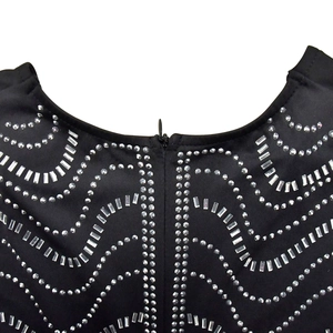 Detailed view of silver rhinestones and sequins with invisible zipper on black dress