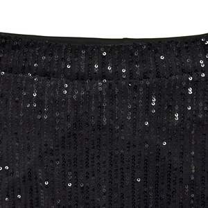 Close-up of black mesh fabric with intricate sequin embroidery and satin hem detail