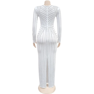 Close-up of white floor-length dress featuring silver rhinestone patterns and back zipper