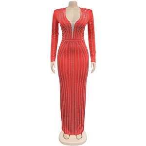 Detail of red floor-length gown featuring shimmering silver rhinestones and deep V-neckline