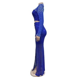 Detail view of blue mesh evening set featuring sequins, pearls and side slit skirt