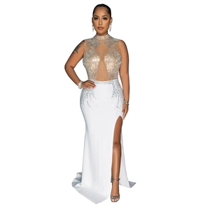 Detailed view of white evening dress featuring mesh patchwork and sparkling rhinestones
