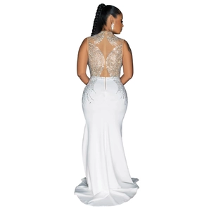 Close-up of elegant white mermaid tail gown with mesh back and shimmering rhinestones
