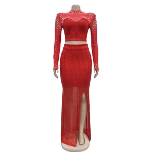 Detail of red sequined dress set with pearl beads on sheer mesh high neck top and slit skirt