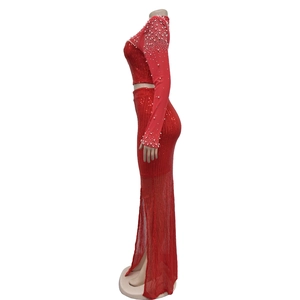 Detail view of red sequin two-piece dress with white faux pearl embellishments on sleeves