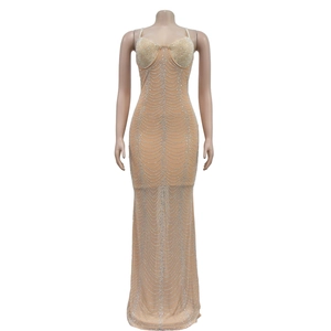 Macro detail of nude mesh evening dress with wave pattern rhinestones and fish tail hem