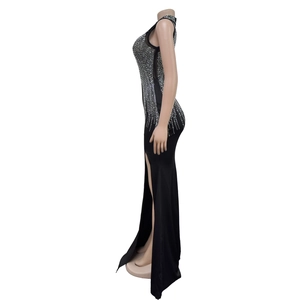 Detail of elegant black mesh evening gown featuring silver rhinestones and a high side slit