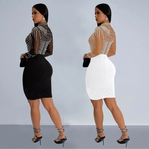 Detail of high neck mesh dress featuring sparkling rhinestones and bodycon fit design