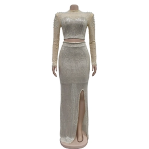 Detail view of champagne mesh dress featuring vertical silver sequins and white pearls