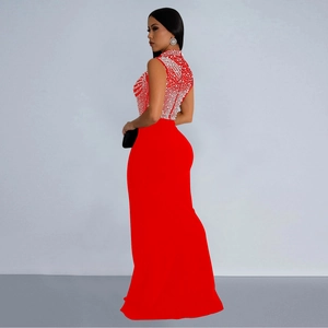 Detail of red sleeveless evening gown featuring intricate pearl and rhinestone embellishments