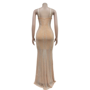 Detailed back view of a beige mesh evening gown with elegant silver rhinestone patterns