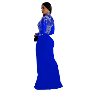 Detail of blue evening gown featuring intricate white pearls and rhinestones on mesh