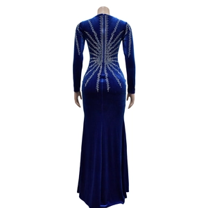 Détail de strass argentés sur le dos d'une robe longue en velours bleu à manches