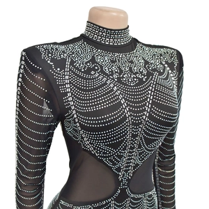 Detail of black turtleneck mesh dress with silver rhinestones and geometric patterns