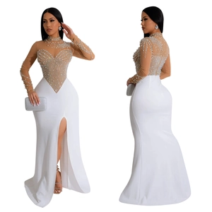 Detail of elegant evening dress with rhinestones, pearls and high slit design