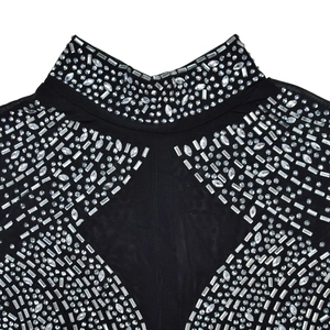 Detailed view of black mesh top featuring intricate silver rhinestone patterns and stand collar