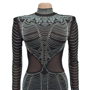 Detail of long sleeve bodysuit with mesh cutouts and silver rhinestones on black fabric