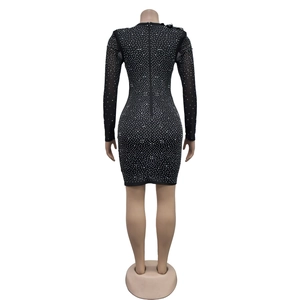 Close-up of black bodycon dress featuring shimmering silver rhinestones and back zipper detail