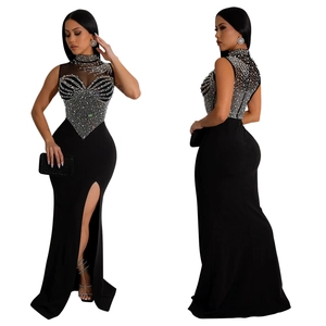 Detail of sheer mesh neckline with sparkling silver rhinestones and high side slit on dress
