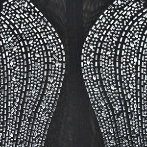 Detail shot of sparkling silver rhinestones on black sheer mesh evening dress fabric
