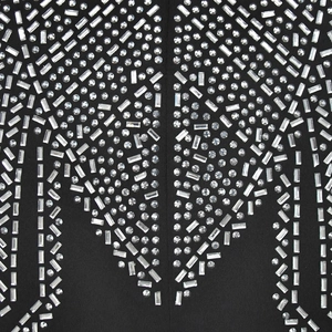 Macro view of geometric rhinestone patterns and crystal detailing on black fabric