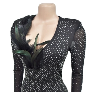 Detail of sheer mesh sleeves and sparkly rhinestones on black feather party dress